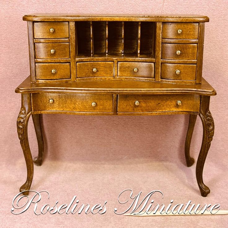 an old wooden desk with drawers on it