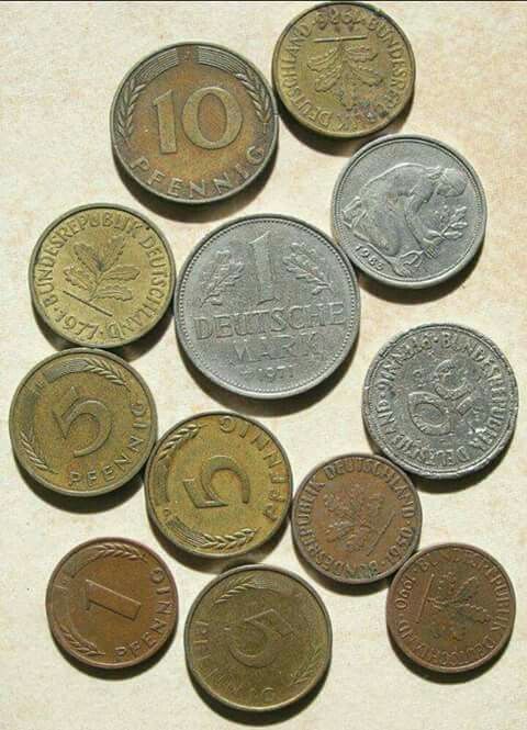 several different types of foreign coins on a table