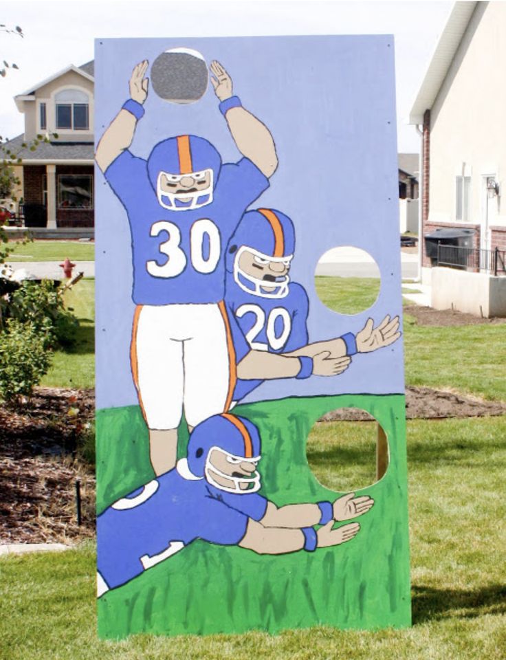 a cardboard cutout of two football players on a field with the number 30 painted on it