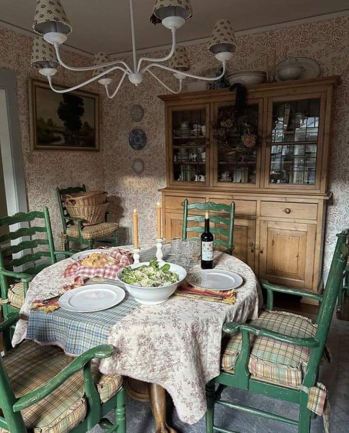 a dining room table with plates and bowls on it