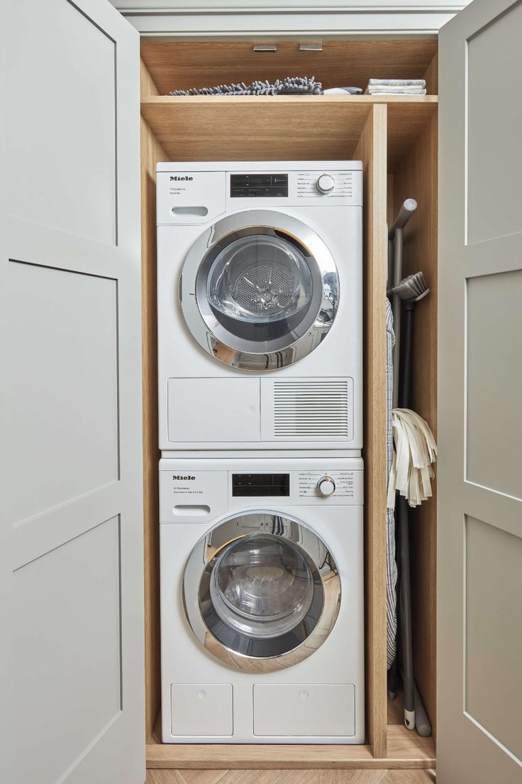 an open washer and dryer in a closet