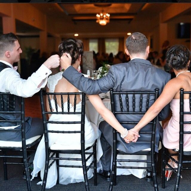 the bride and groom are sitting at the table