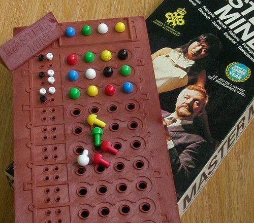 a board game sitting on top of a wooden table next to a book and magazine