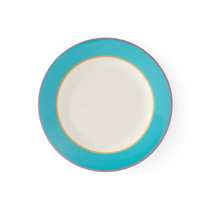 a blue and white plate sitting on top of a white table next to a wall