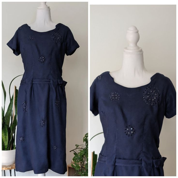 "This 1940s navy blue dress is adorned with embroidered flowers with small gems attached. Perfect party dress, tea dress, day dress! I love the details on the neckline and dropped waist belt that weaves thru dress and attaches with a bow detail.   Era: 1940s Brand: no tag. Side and back metal zipper  Size:  see measurements for best fit  Measurements: B 18\" ptp;  W 15\" flat; Hip where belt sits 16\" flat; lower hip 18 1/2\" flat; L 40\"  Fabric: cotton Condition: Very good.. Ready to wear. Item has been washed and air dried  ** Flaws: loose threads on one embroidery flower and belt has been temp shortened with safety pins and snaps (Easily undone) Function: side zip and back shorter zipper Please feel free to ask questions to ensure best fit. This is a vintage piece and as such will have Navy Sheath Dress, Safety Pins, Navy Blue Dress, Navy Blue Dresses, Tea Dress, Day Dress, Metal Zipper, Perfect Party, Bow Detail