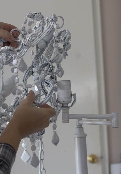 a person is working on some kind of chandelier