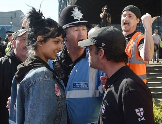 a group of people standing next to each other with the words smiling in the face of the far right hand