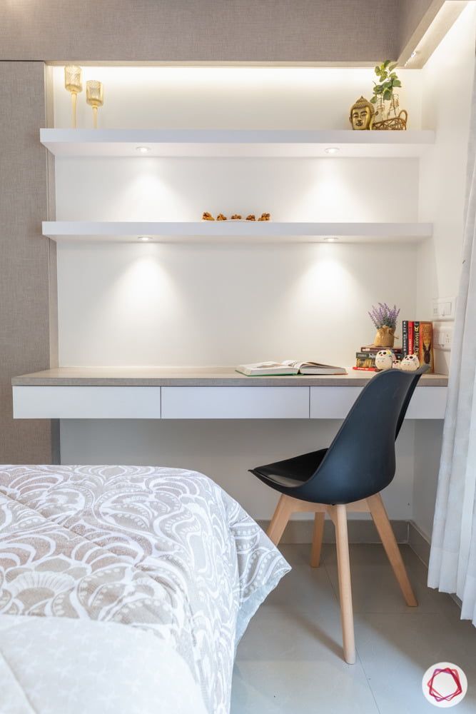 a bedroom with a bed, desk and shelves