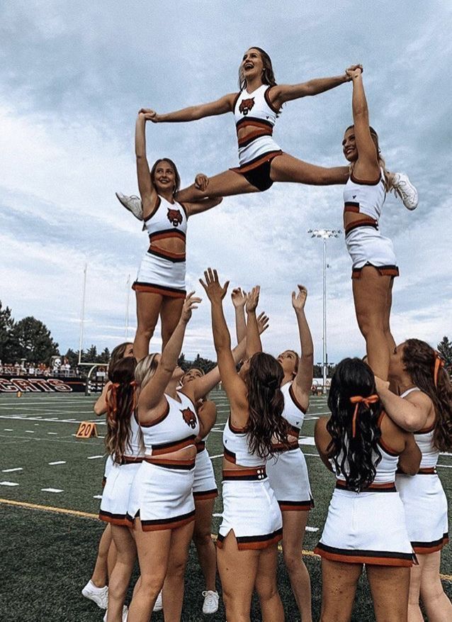 a group of cheerleaders standing on top of each other