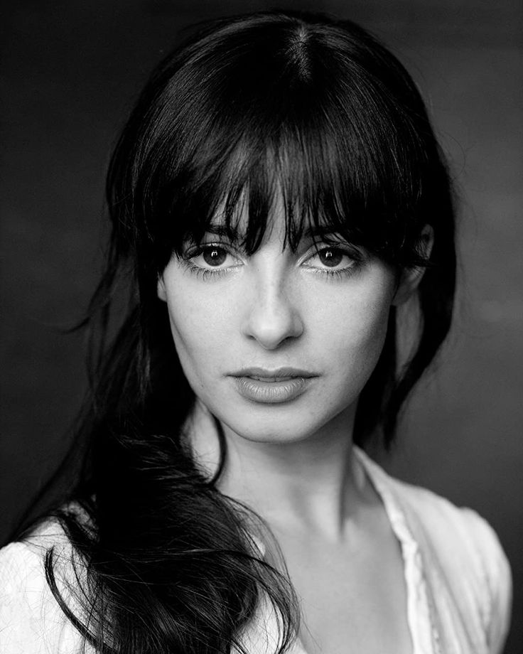 a black and white photo of a woman with long hair