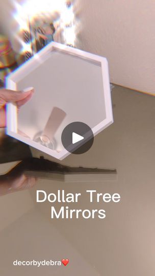 a person holding a mirror with the words dollar tree mirrors in front of them on it