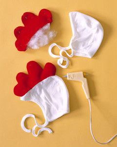 two white and red hats with hearts attached to them