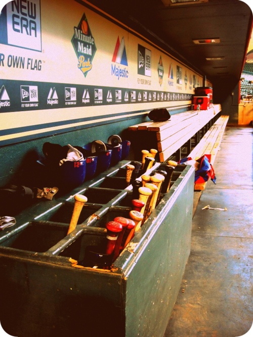 the baseball dugout is filled with buckets and cups