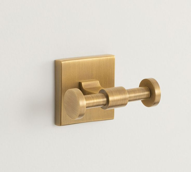 the brass toilet paper holder has two rolls on it's side and is attached to the wall