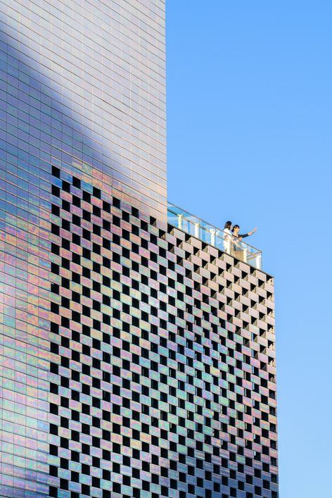 a tall building with a sign on top that says it's time to go