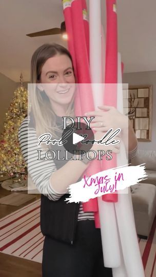 a woman is holding two large pink and white poles in her hands, with the words diy christmas columns