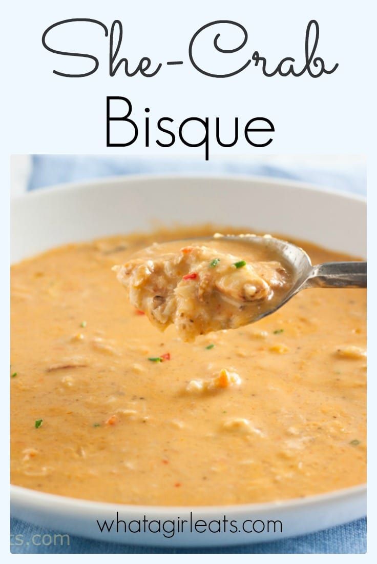 a spoon full of soup with the words she crab bisque on it and an image of