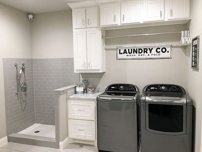 a laundry room with two washers and dryer