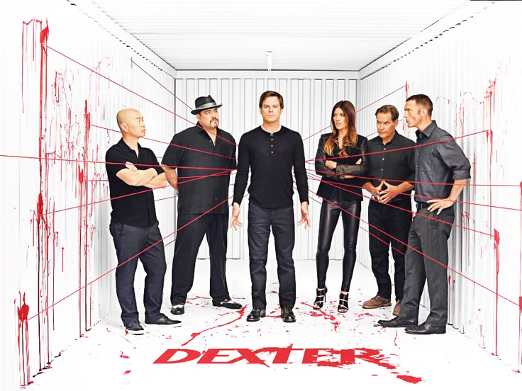 the cast of modern family standing in a room with red paint splattered all over it