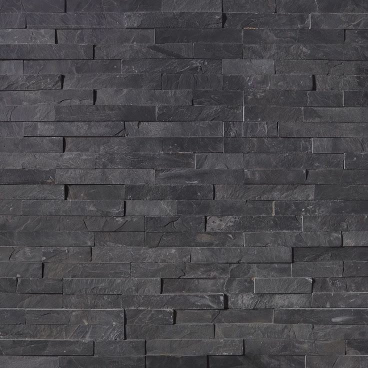 a black brick wall with no mortars on it