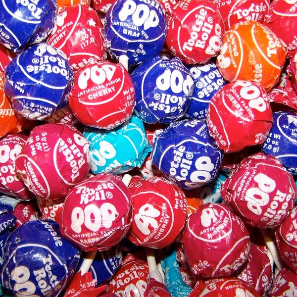 many colorful candies are stacked on top of each other