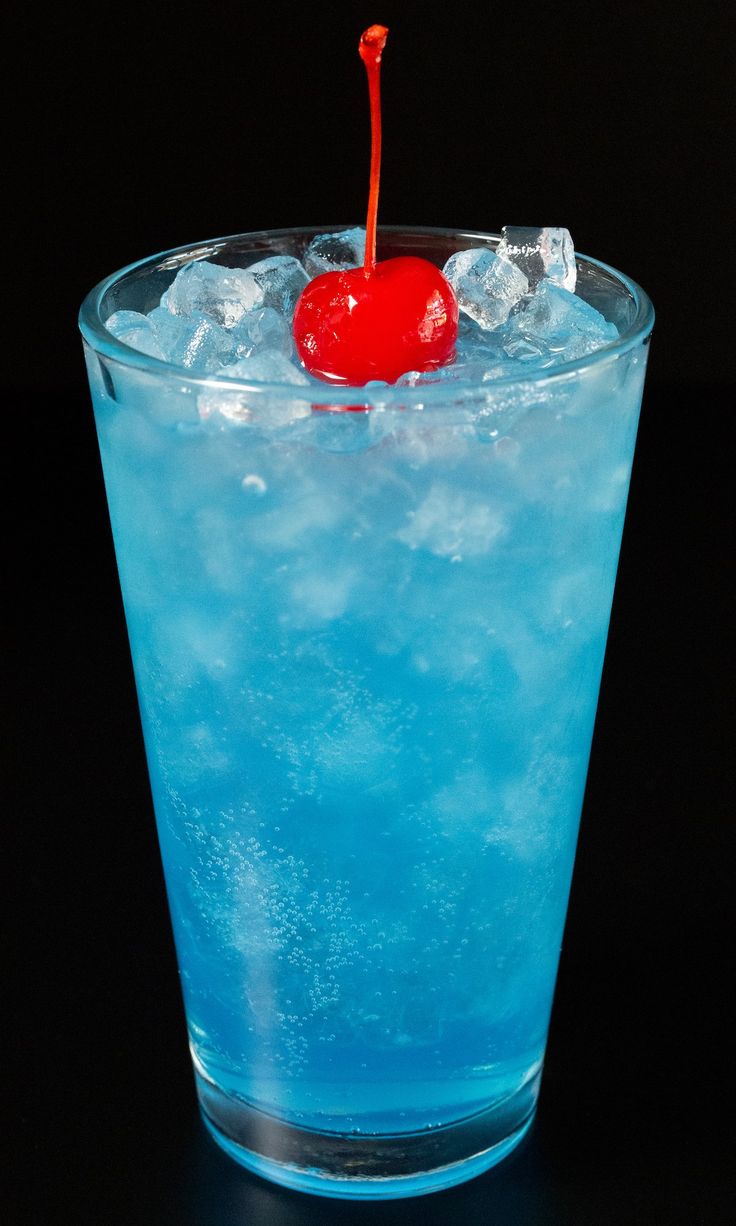 a blue drink with a cherry on the top