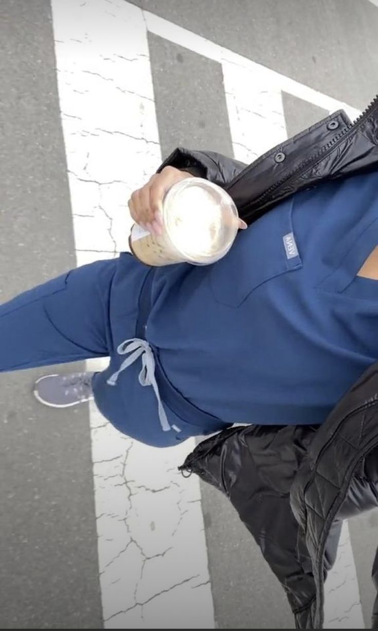 a man in blue shirt drinking from a cup