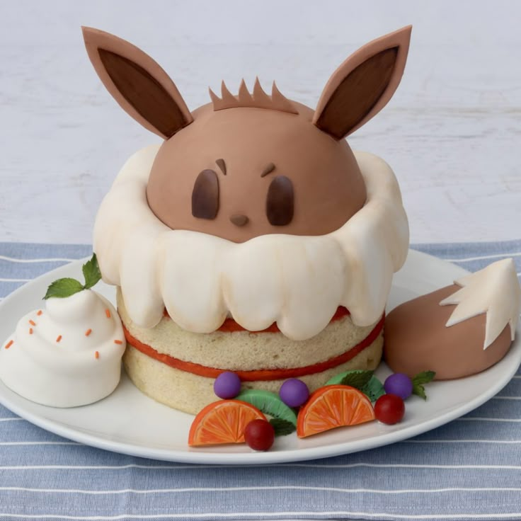 a cake decorated with icing and fruit on a plate