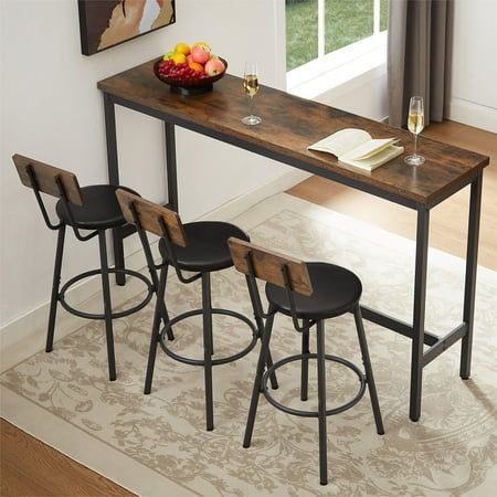 a table with four stools and a bowl of fruit on the counter top next to it