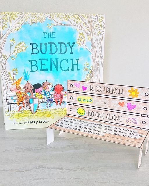 two children's books sitting next to each other on top of a wooden bench