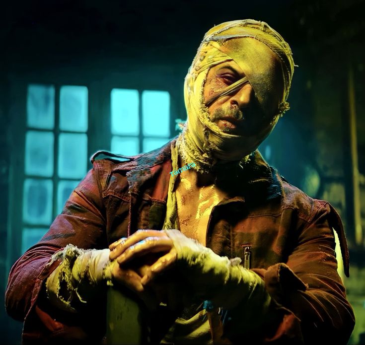 a man with yellow paint on his face and hands