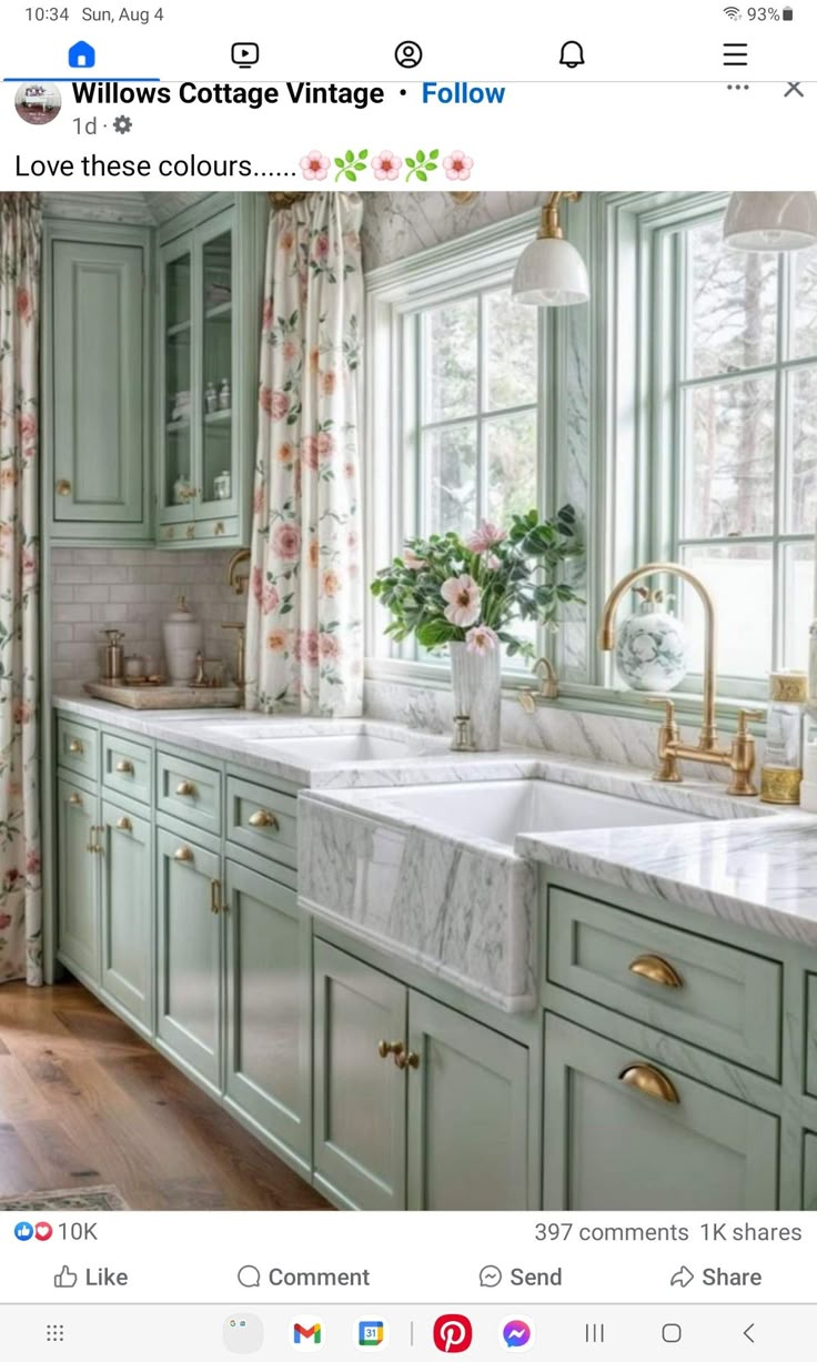 a kitchen with green cabinets and white marble counter tops is featured in the instagram