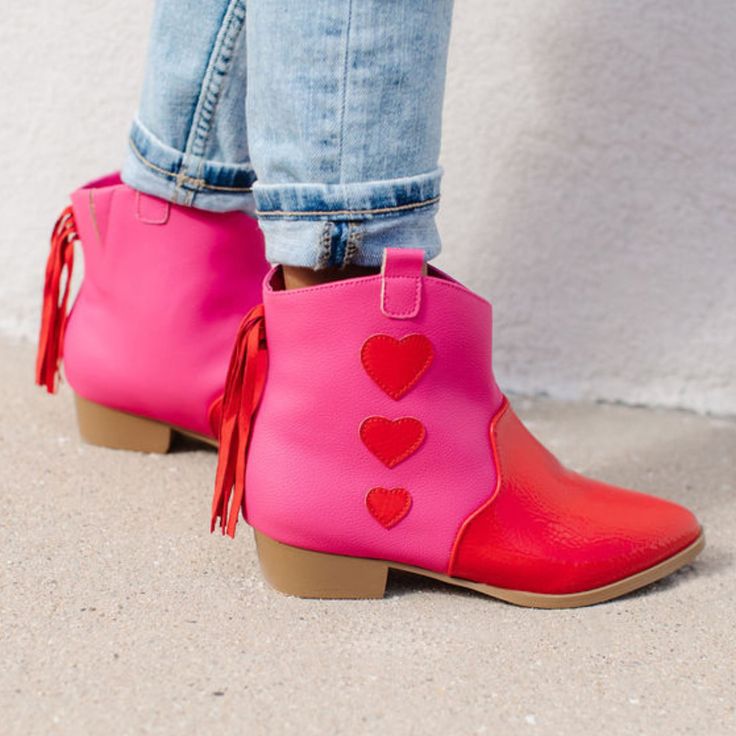 Let her steal the spotlight with the Miss Dallas Heart Western Boots, the perfect blend of sweetness and style. Bursting with bold colors and playful details, these boots are designed to showcase her fun-loving personality. The vibrant pink and red combo is complemented by adorable hearts and eye-catching fringe tassels at the back, creating a look that's as charming as it is unique. Synthetic upper, lining & sock Approx. 1.2" block heel height Pull tabs & hidden gore provide easy on/off Inside Yosi Samra Flats, Heart Boots, The Great White, Western Boot, Red Hearts, Heart For Kids, White Flats, Pink And Red, Knitwear Tops