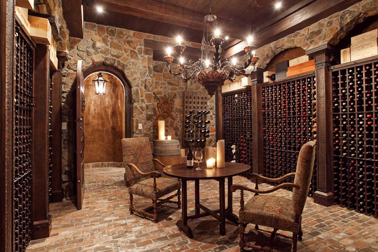 a wine cellar with two chairs and a table