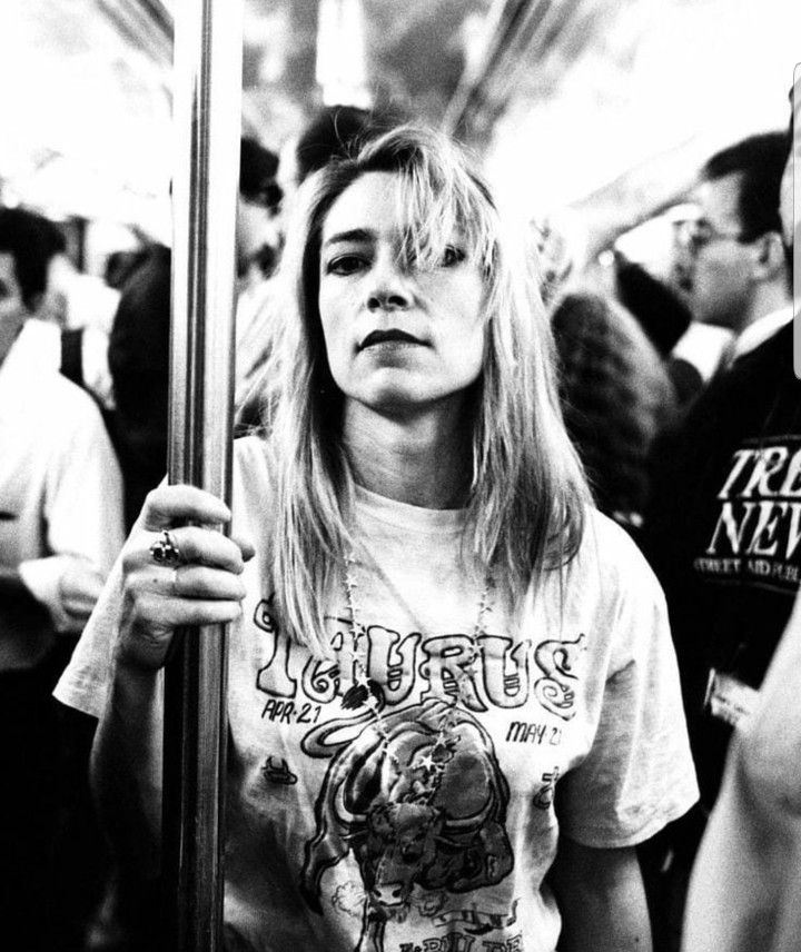 a black and white photo of a woman on a subway