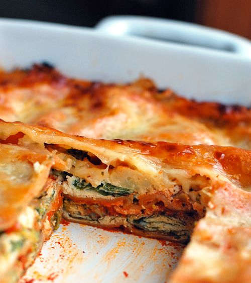 a casserole dish with cheese and spinach in it's bottom half