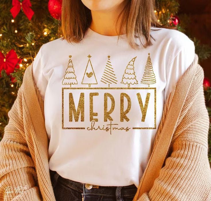 a woman standing in front of a christmas tree wearing a t - shirt that says merry