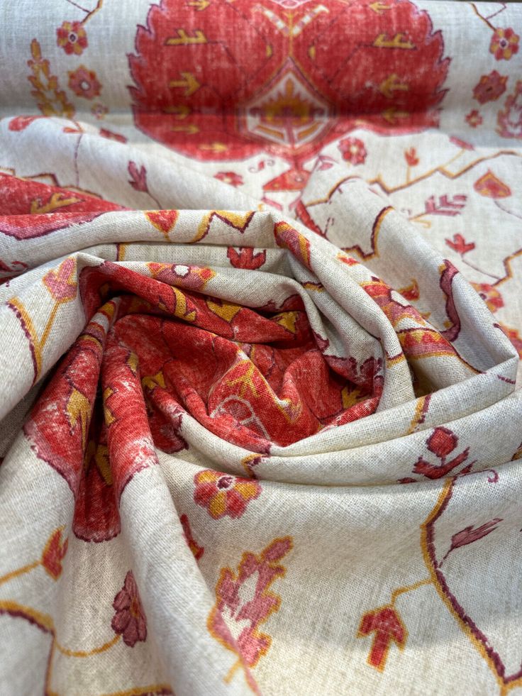 a red and white floral print fabric with yellow flowers on the bottom half of it