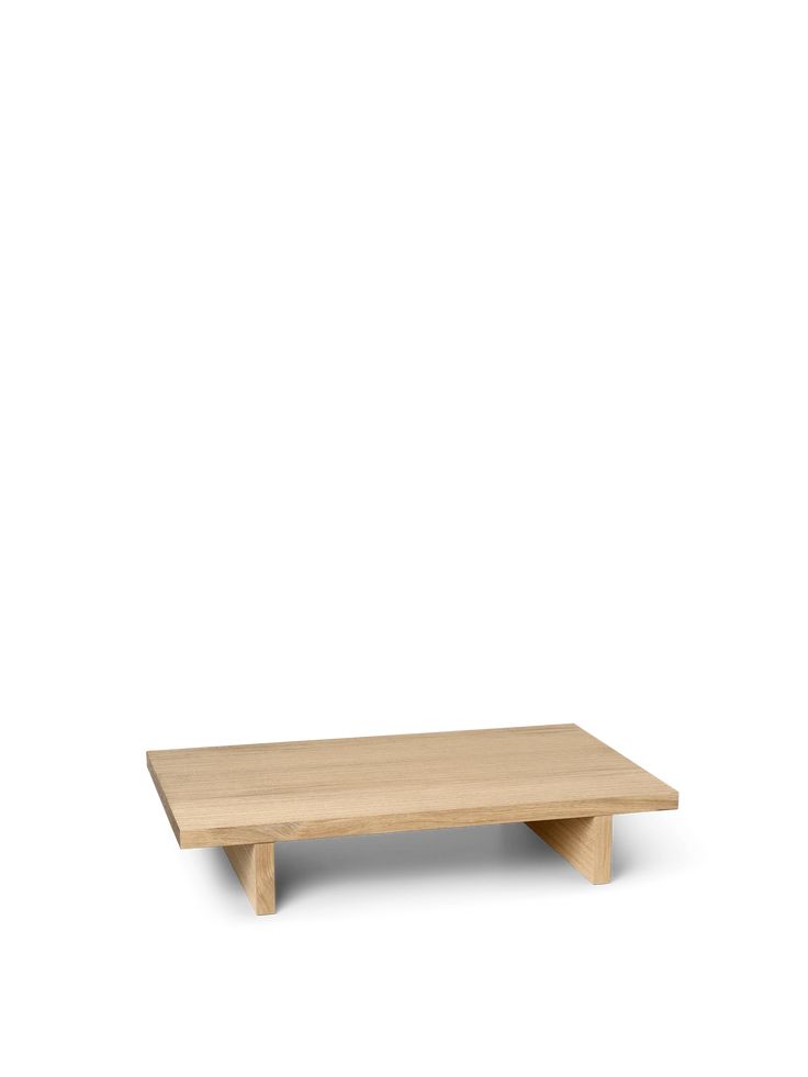 a wooden table sitting on top of a white wall