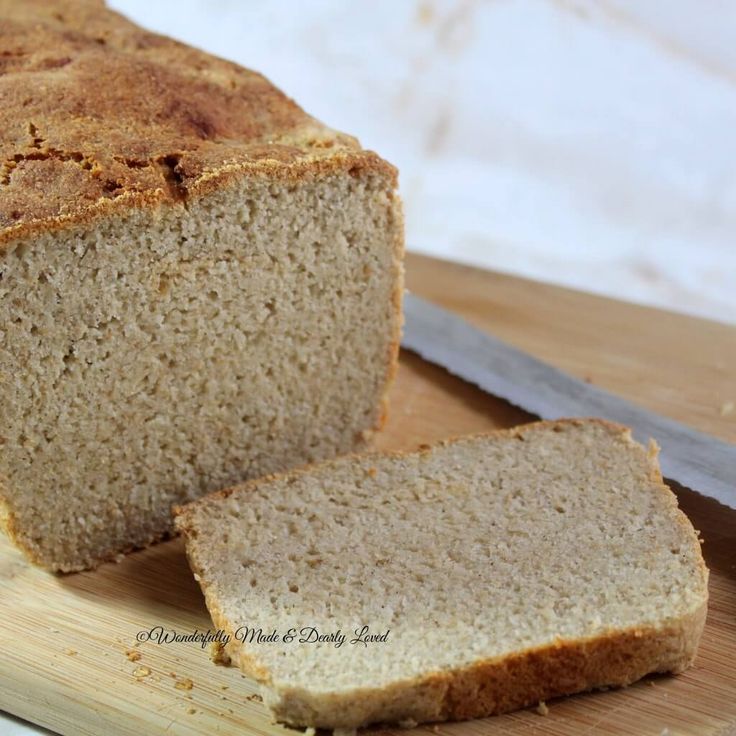 a loaf of bread sitting on top of a cutting board next to a knife