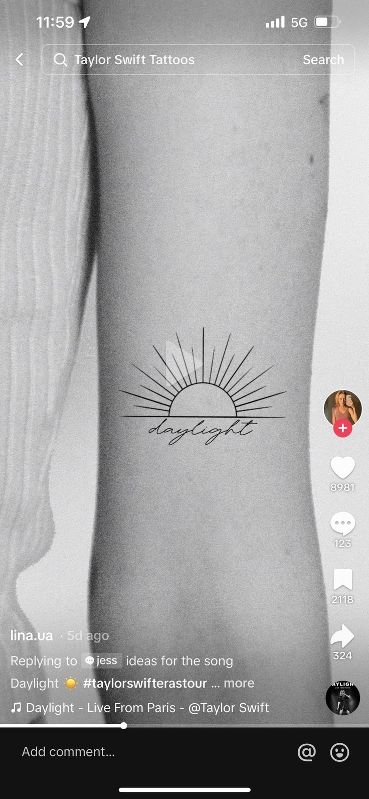 the back of a person's arm with a sun tattoo on it, in black and white