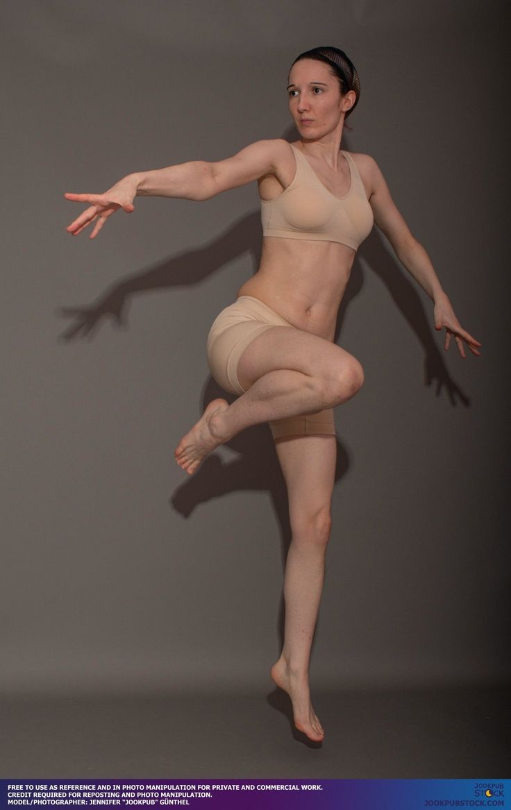 a woman in nude clothing is posing with her arms outstretched and legs spread out to the side