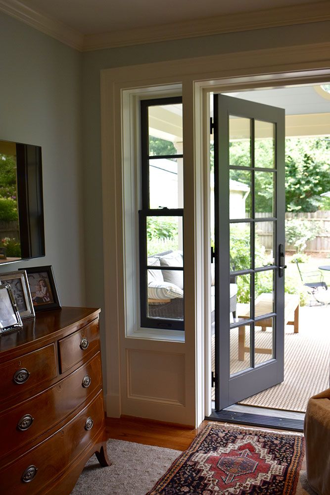 an open door leading into a living room with a rug on the floor next to it