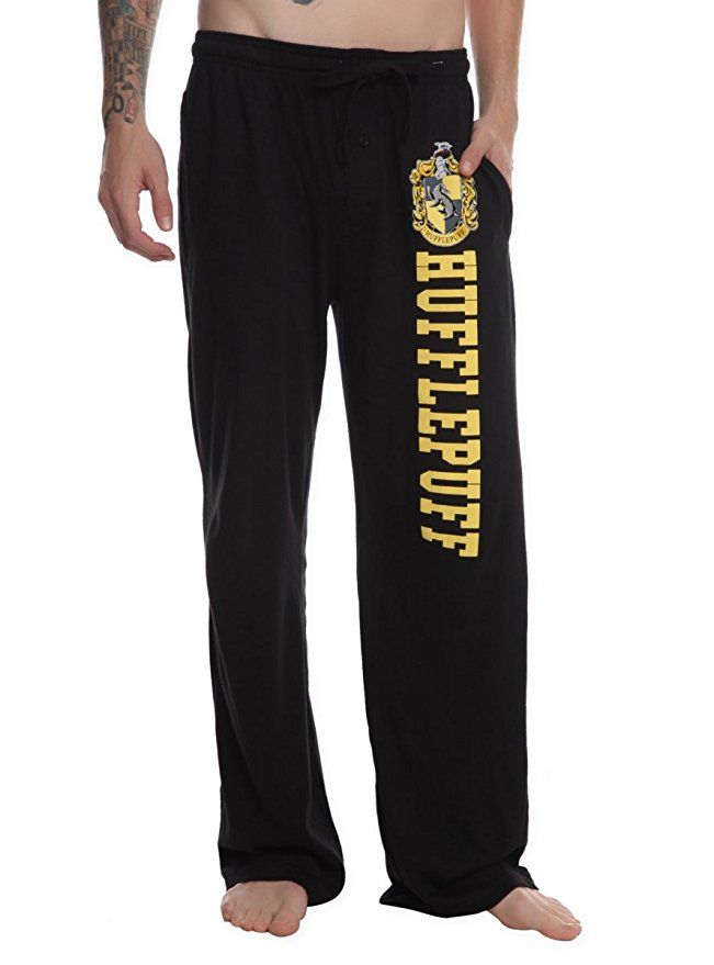 a man wearing harry potter pants with the hogwarts on it