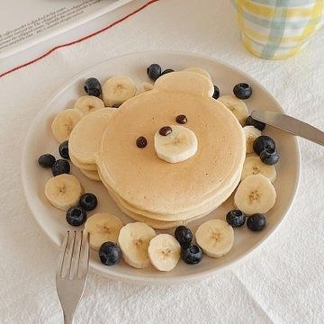 pancakes with bananas and blueberries are on a plate