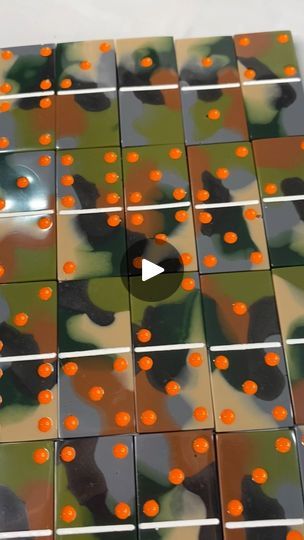 an array of tiles with orange dots in the middle and black dots on them, all arranged together