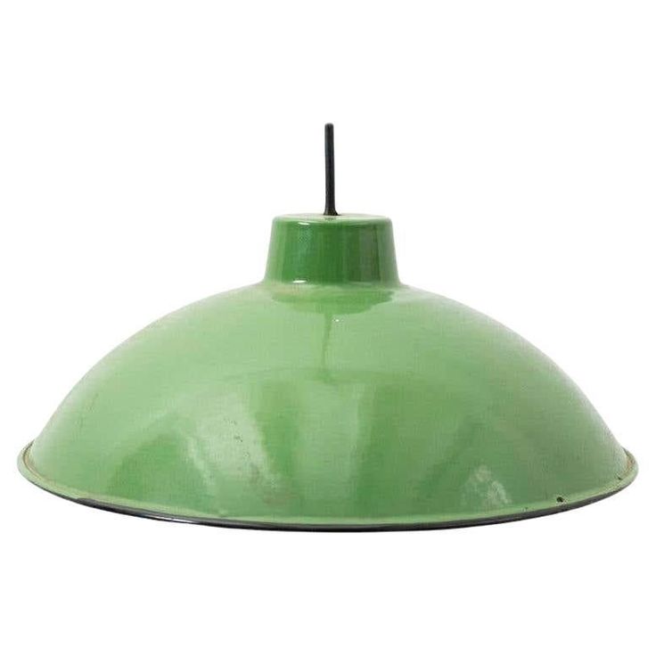 a green hanging light on a white background