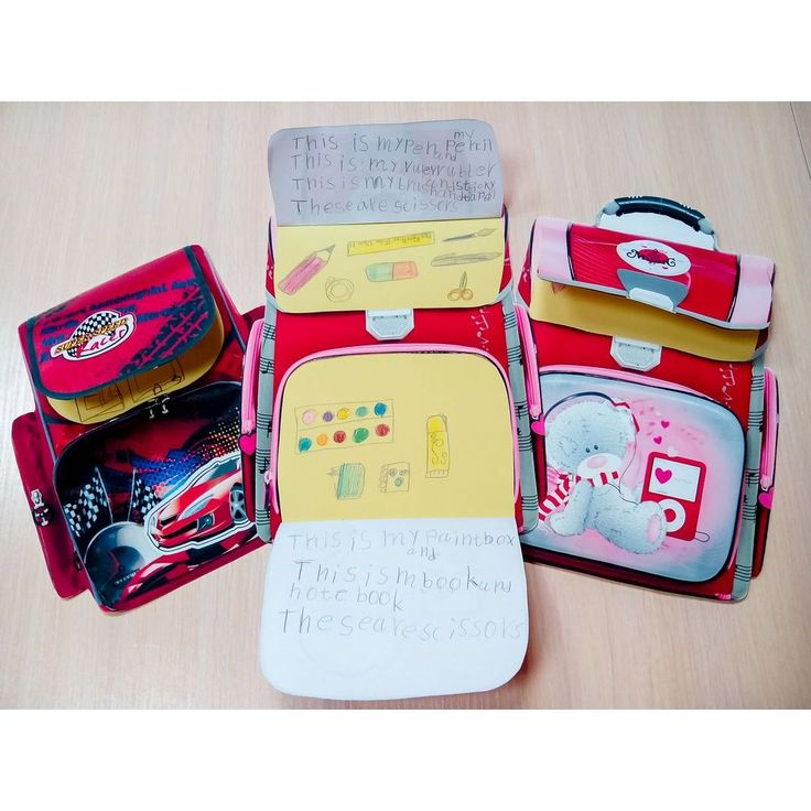 four pieces of luggage sitting on top of a wooden table next to each other with writing on them