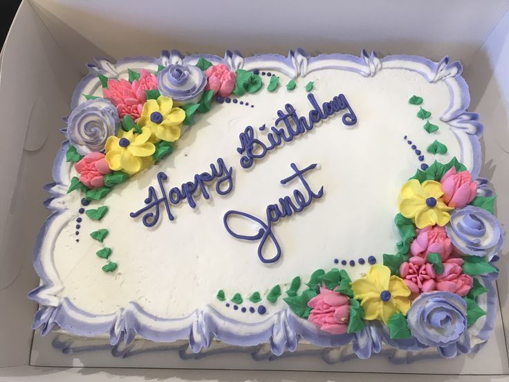 a birthday cake in a box with flowers on it