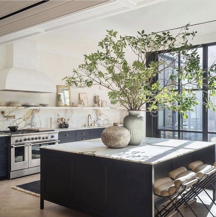 a kitchen with marble counter tops and an island in front of a stove top oven